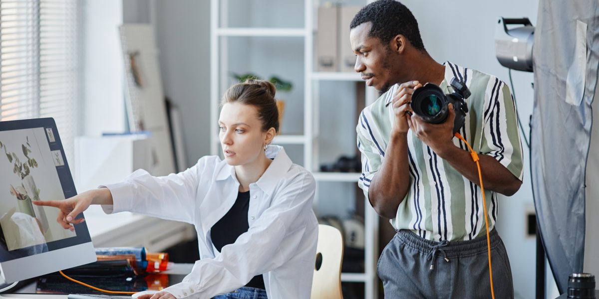 Two Photographers Working In Studio